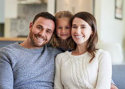 Buy stock photo Shot of a young family relaxing on the couch at home