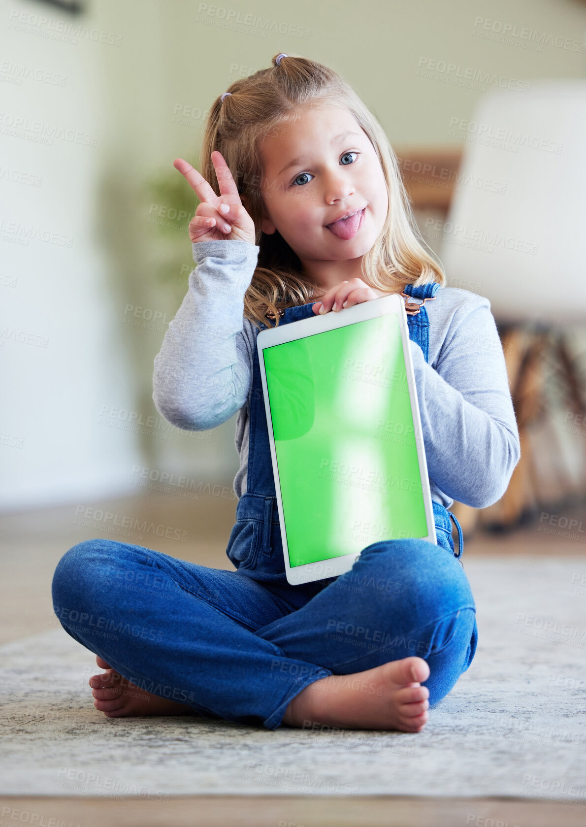 Buy stock photo Shot of a little girl showing a peace sign while using a digital tablet at home