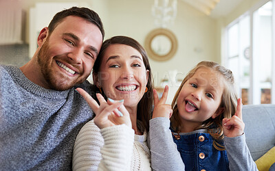 Buy stock photo Parents, girl and peace sign on sofa for selfie in home for bonding, love and memories. People, family and kid on portrait with smile in living room on couch for fun, enjoy and relax for social media