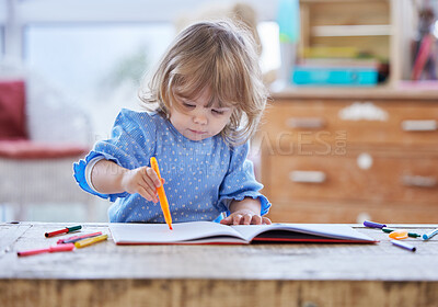 Buy stock photo Shot of a little girl drawing at home