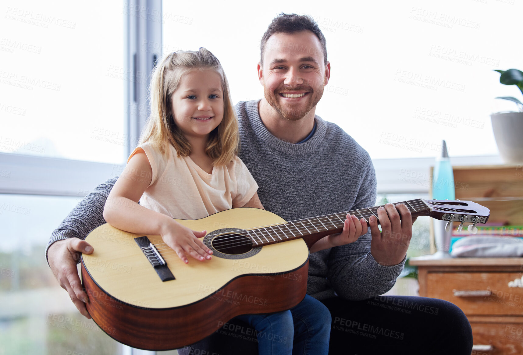 Buy stock photo Dad, teaching and guitar for daughter, portrait and smile for playing, music and listening with kid. House, learning and girl with father for lesson, lounge and growth with development for child