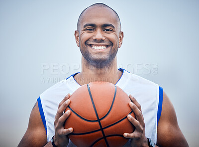 Buy stock photo Shot of a young male basketball player holding the ball