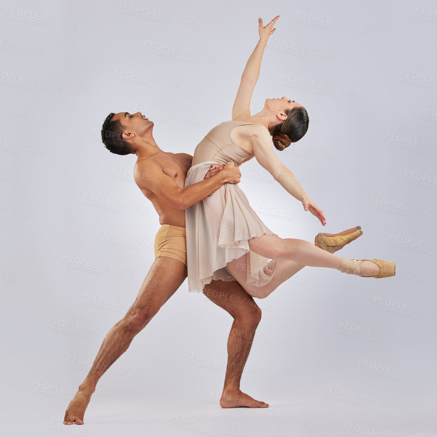 Buy stock photo Studio shot of a young man and woman performing a ballet recital against a grey background