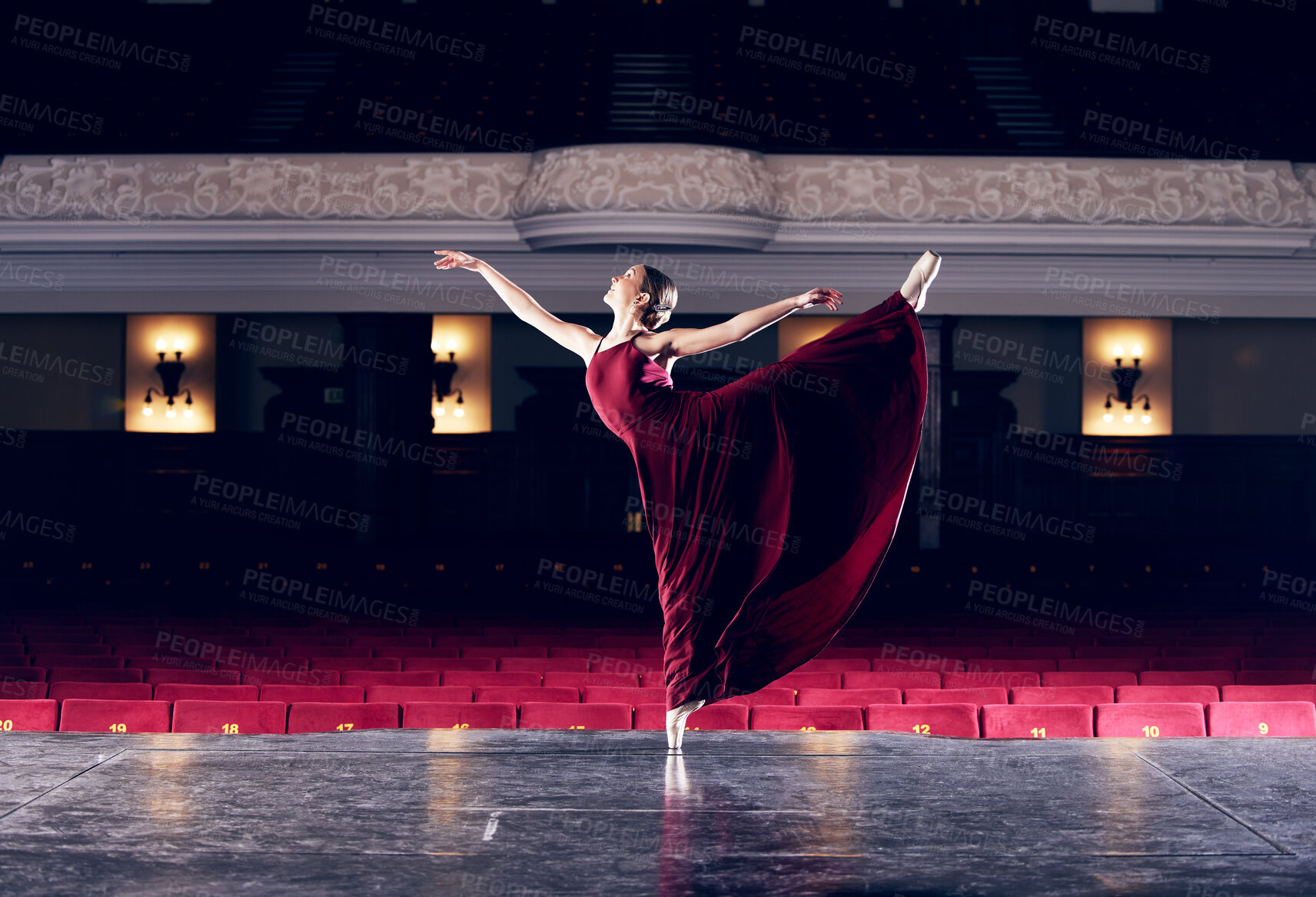 Buy stock photo Shot of a ballerina performing her routine in a theater