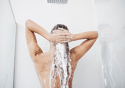 Buy stock photo Shot of a woman washing her hair in the shower
