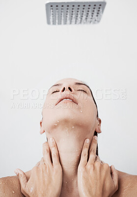 Buy stock photo Shot of a young woman enjoying a shower at home