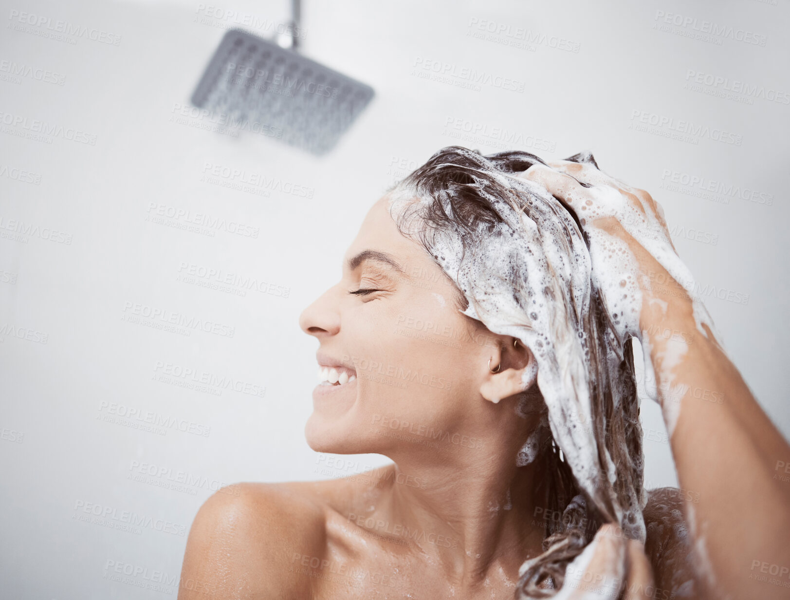 Buy stock photo Shot of a woman washing her hair in the shower