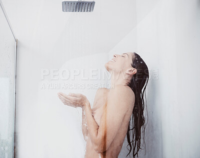 Buy stock photo Shot of a young woman taking a shower