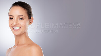 Buy stock photo Shot of a beautiful young woman posing against a grey background