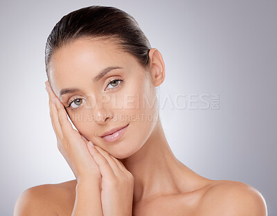 Buy stock photo Woman, portrait and hands in studio for skincare or wellness aesthetic, clean and calm for dermatology. Female person, gray background and natural glow, self care or confidence with transformation