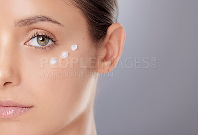 Buy stock photo Woman, studio and cream on half face for skincare, moisturizer and ointment on gray background. Female person, clean and clear skin by dermatology or lotion, beauty and spf treatment for hydration