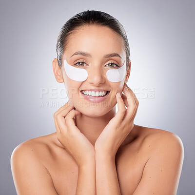 Buy stock photo Woman, studio and portrait for eye pads, skincare and mask for hydration on dark circles on gray background. Female person, hyaluronic acid and beauty by dermatology or treatment, pamper and patches