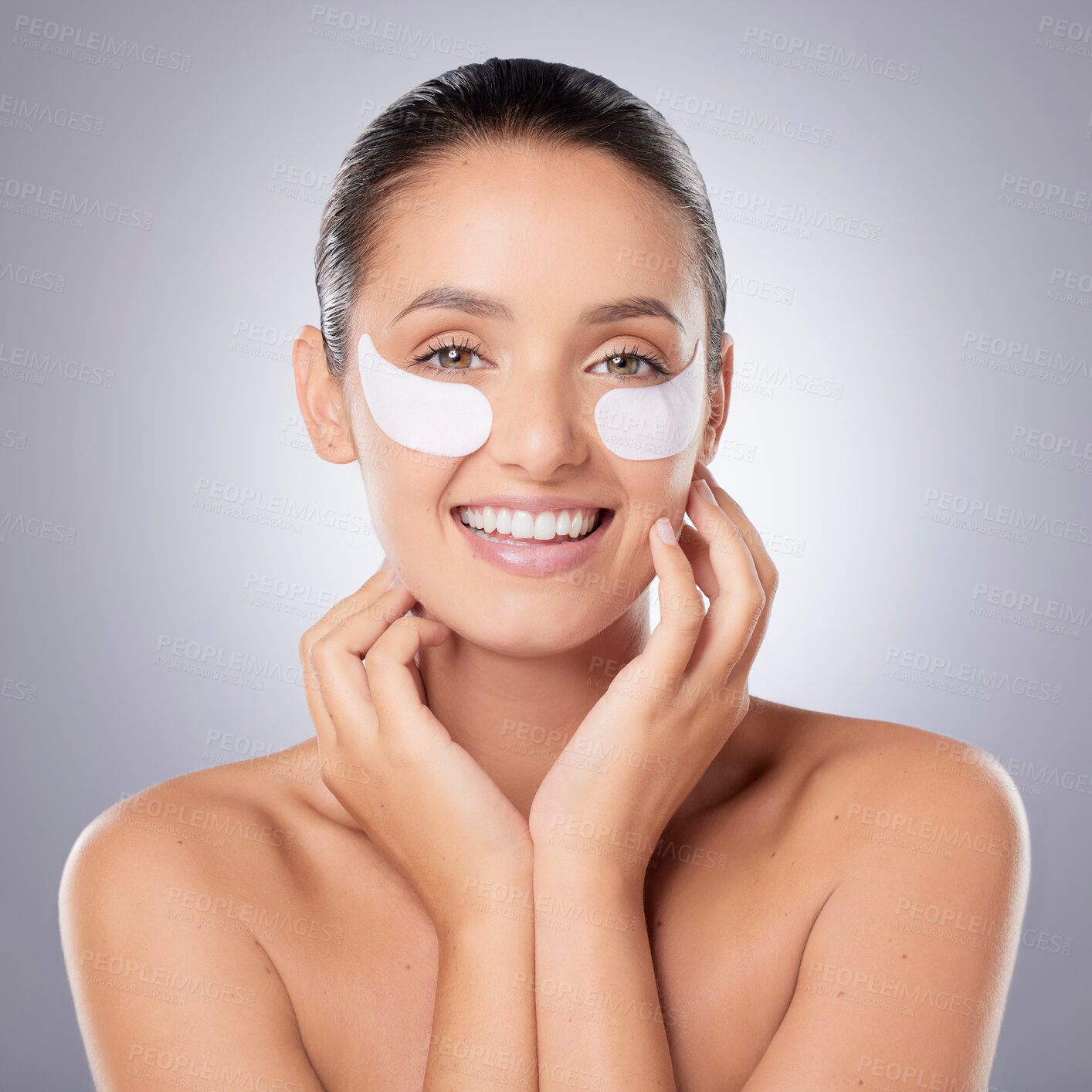 Buy stock photo Shot of a young beautiful woman wearing under-eye patches against a grey background