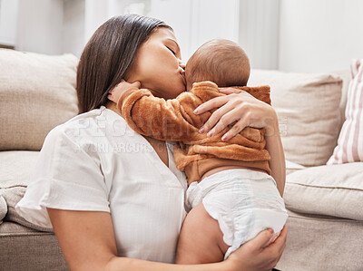 Buy stock photo Shot of a mother cuddling and kissing her son