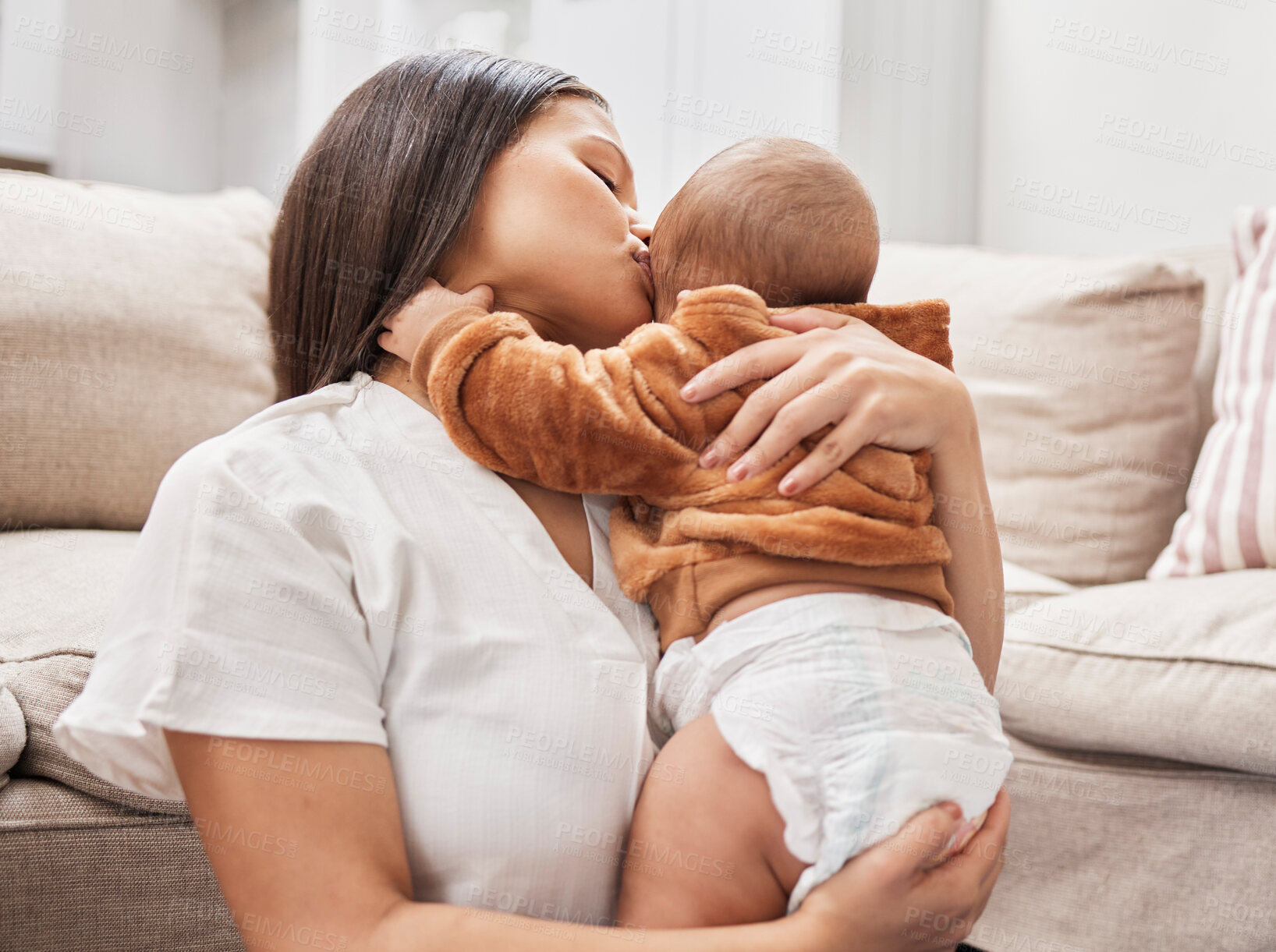 Buy stock photo Shot of a mother cuddling and kissing her son