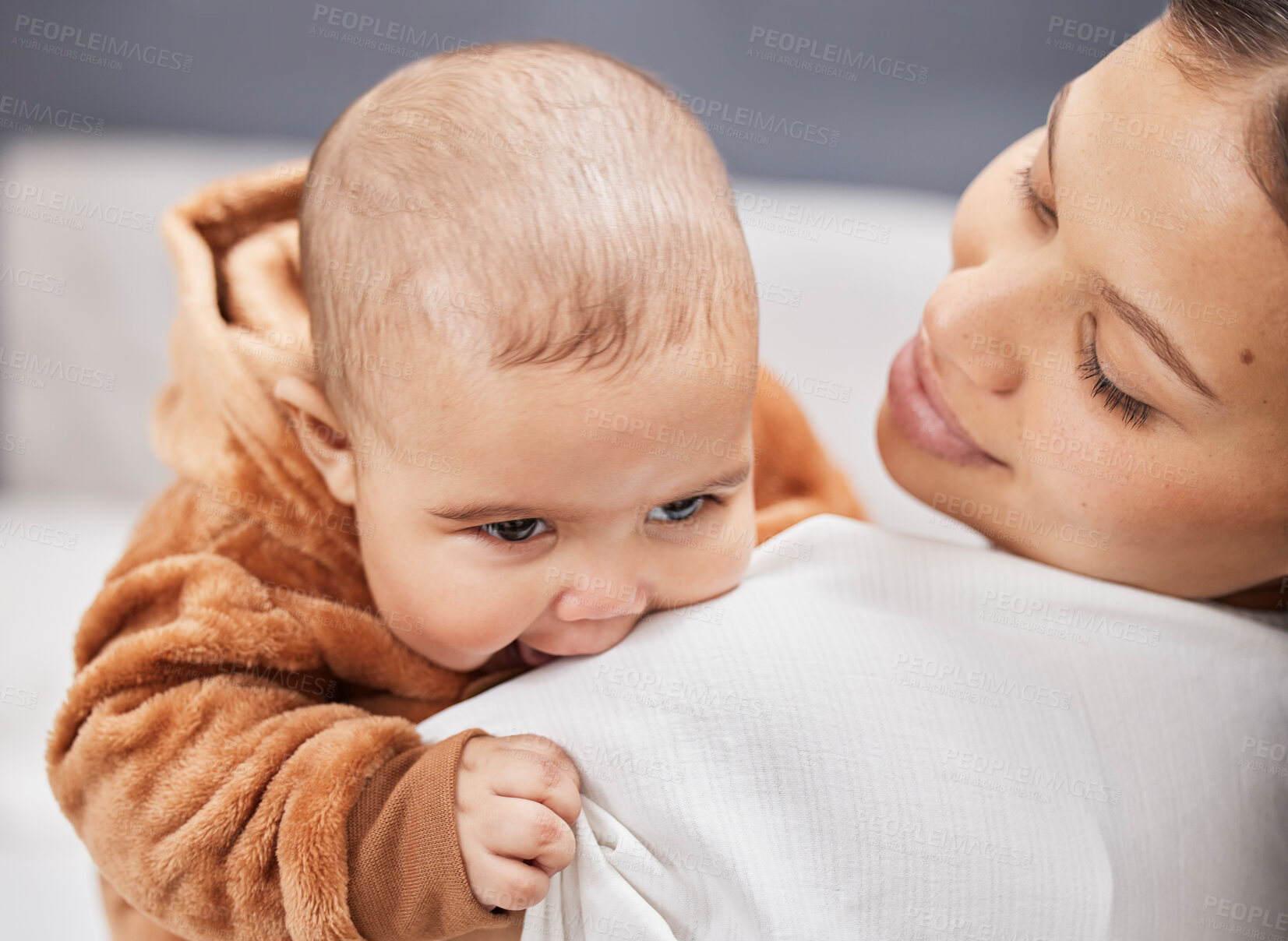 Buy stock photo Shot of a young mother holding her baby boy