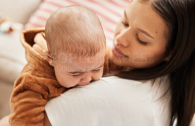 Buy stock photo Shot of a young mother consoling her crying baby