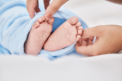 Buy stock photo Shot of a mother covering her baby's feet with a blanket as he sleeps