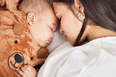 Buy stock photo Shot of a young mother snuggling with her baby boy as he sleeps