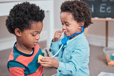 Buy stock photo Shot of a boy using a toy stethoscope on his