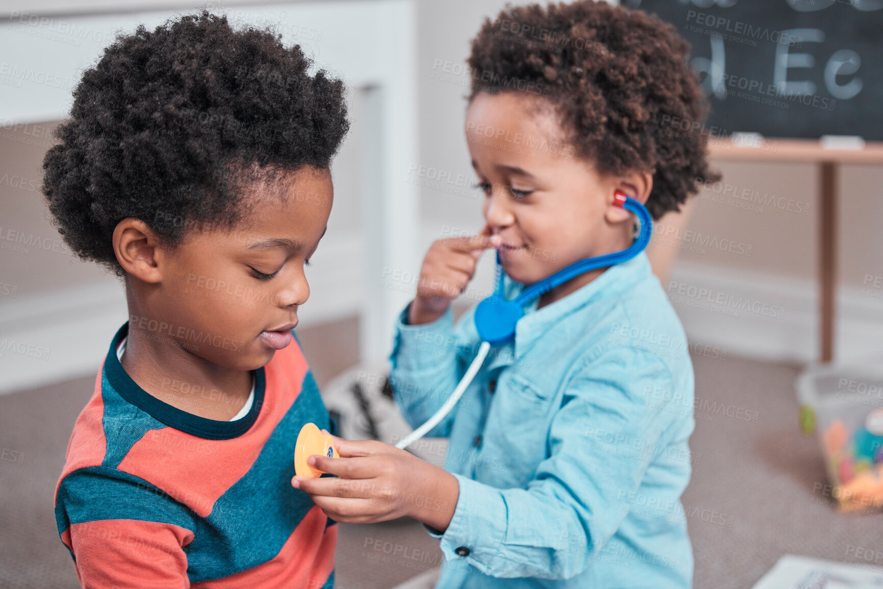 Buy stock photo Shot of a boy using a toy stethoscope on his