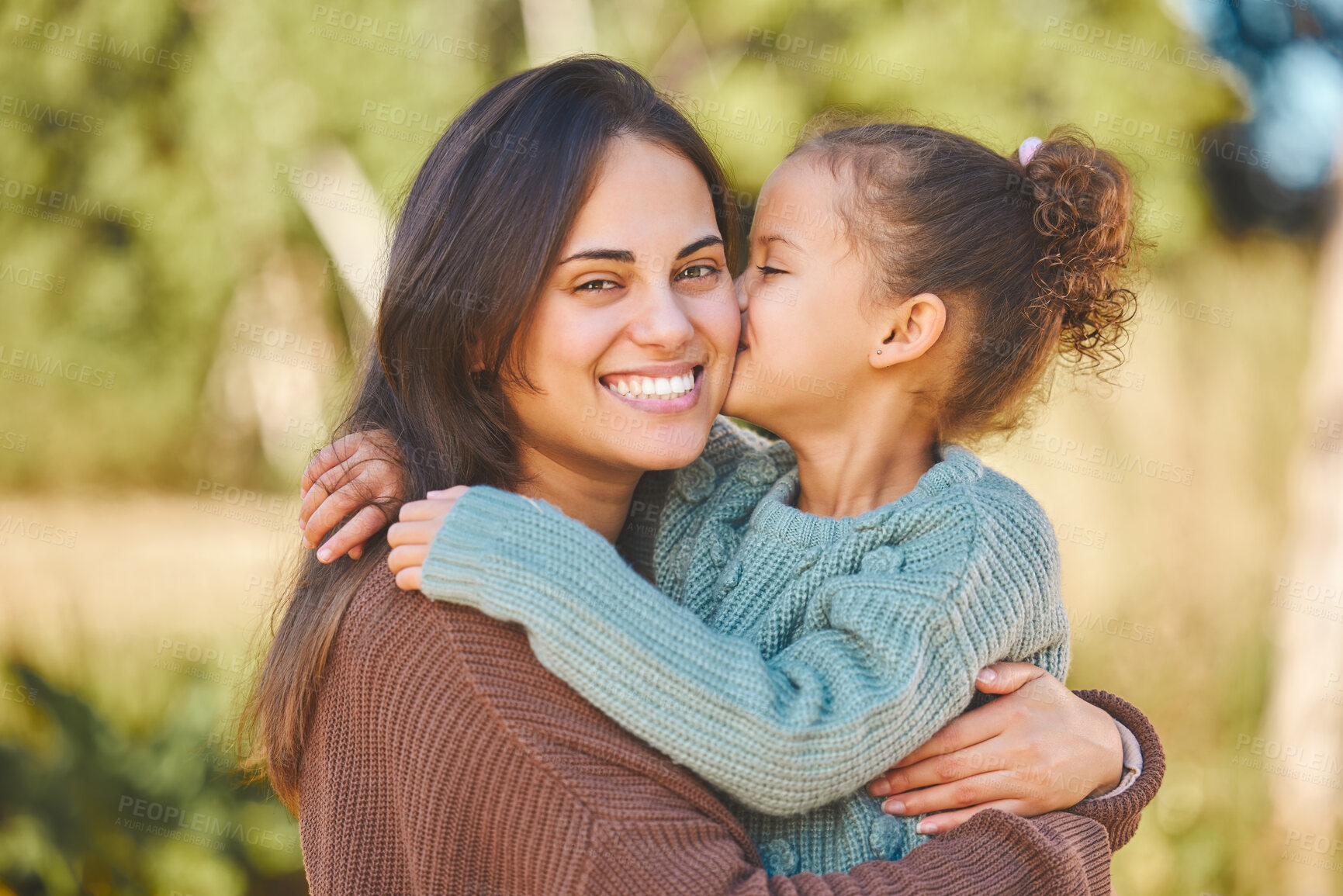 Buy stock photo Shot of a little girl kissing her mother on the cheek