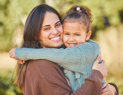 Buy stock photo Shot of a young mother and daughter hugging