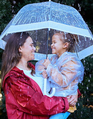 Buy stock photo Shot of a mother playing in the rain with her daughter