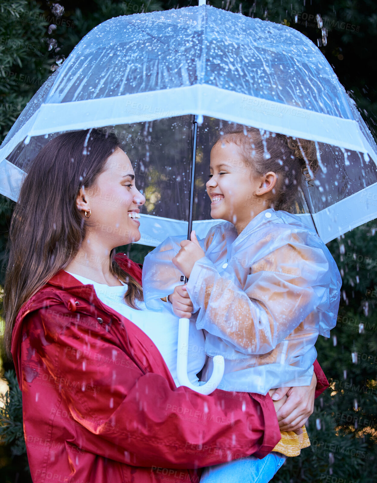 Buy stock photo Shot of a mother playing in the rain with her daughter