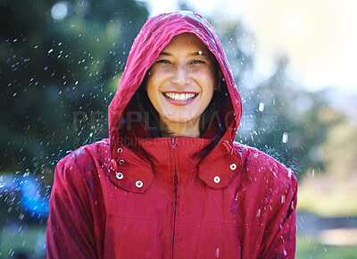 Buy stock photo Shot of a young woman enjoying the rain outside