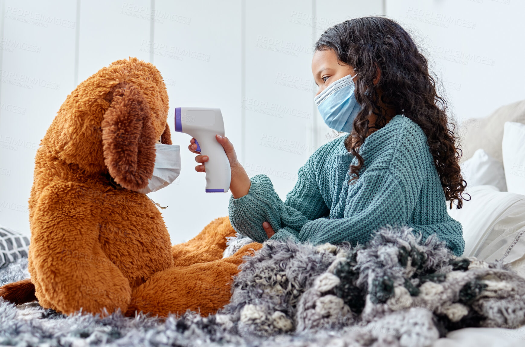 Buy stock photo Health, teddy bear and child with thermometer on bed for virus prevention, safety or fever in bedroom. Playing, toy animal and young girl with mask for medical care, wellness or disease protection