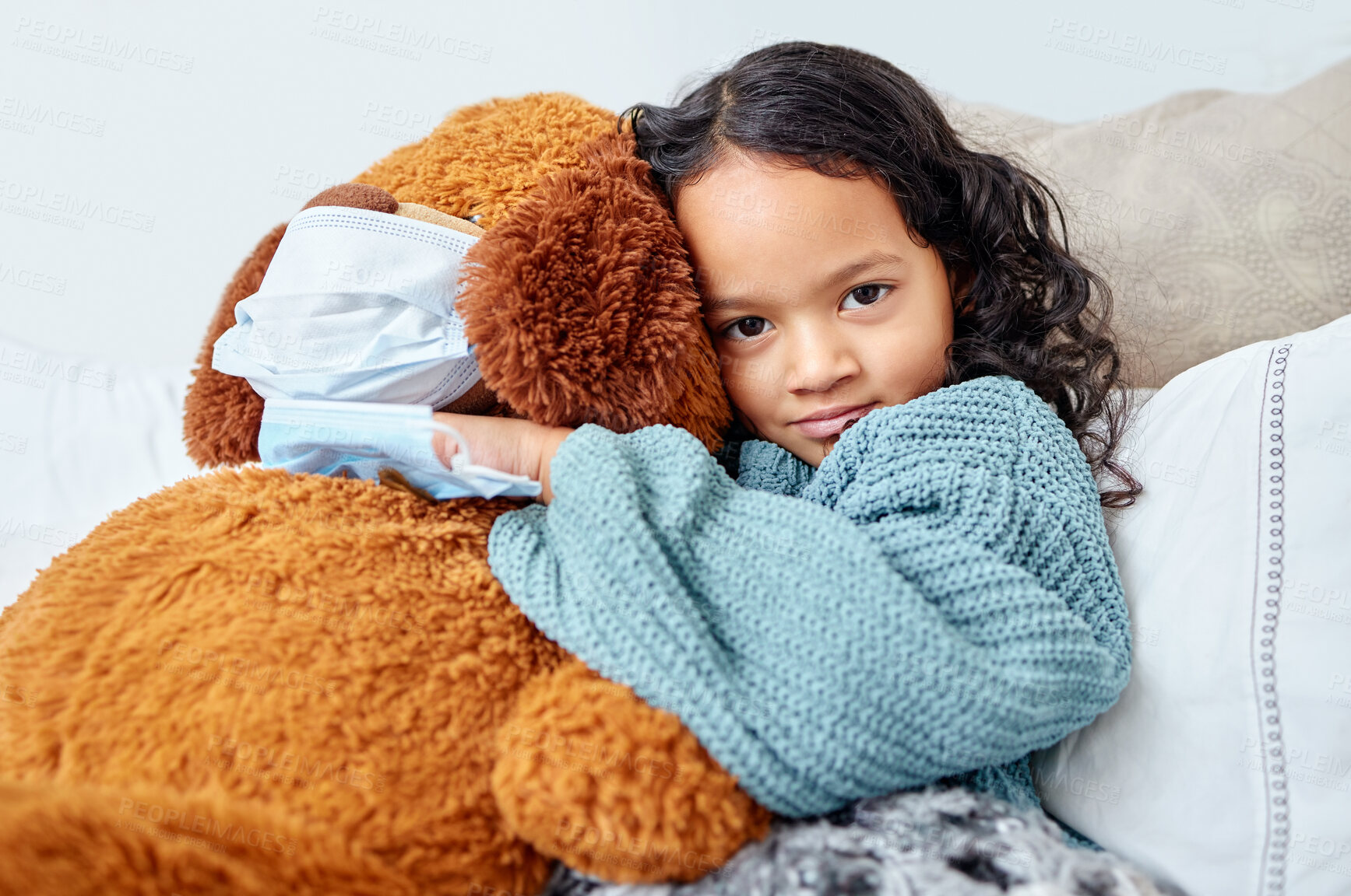 Buy stock photo Girl child, portrait hug and teddy bear in bed with face mask for sick, virus and relax in home. Young kid, happy cuddle and toy animal with safety for healthcare, infection and risk for disease