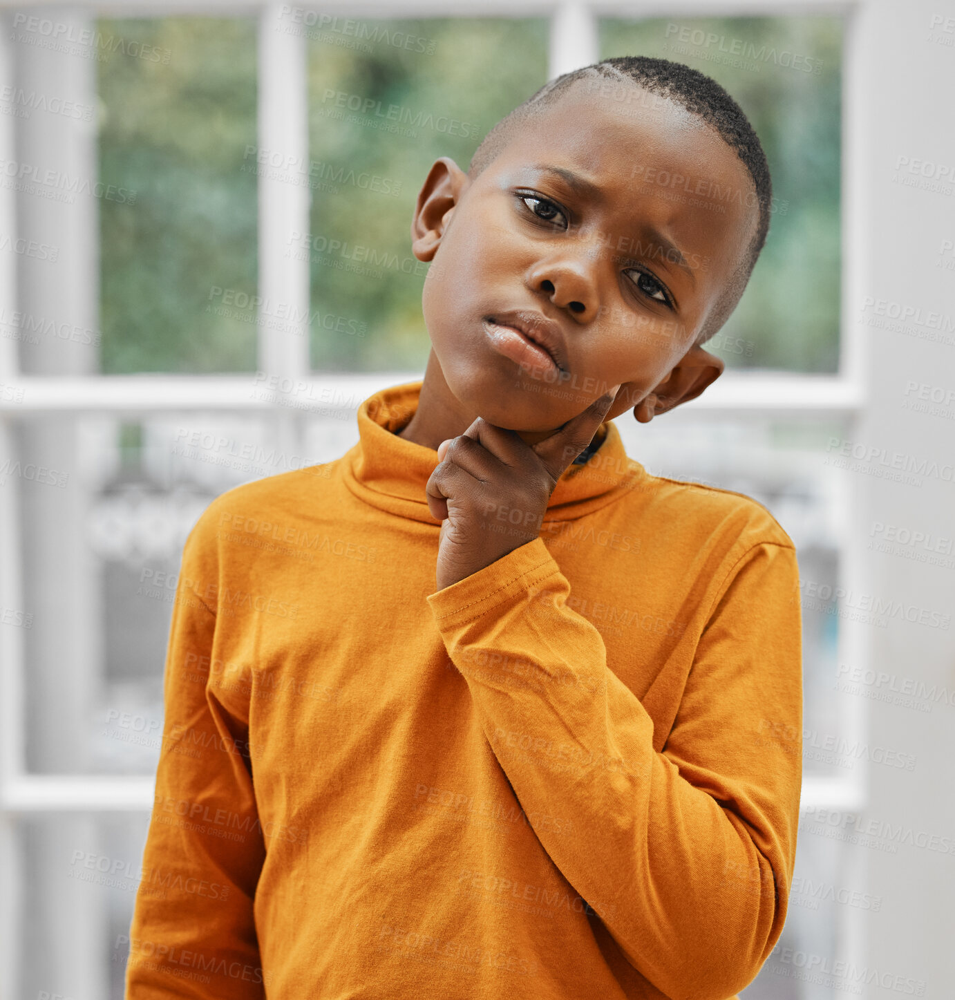Buy stock photo Shot of a little boy looking unhappy at home