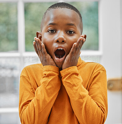 Buy stock photo Shot of a little boy looking shocked at home