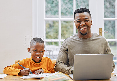 Buy stock photo Shot of a young father using a laptop while his son does homework at home