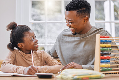 Buy stock photo Shot of a young father helping his daughter with homework at home