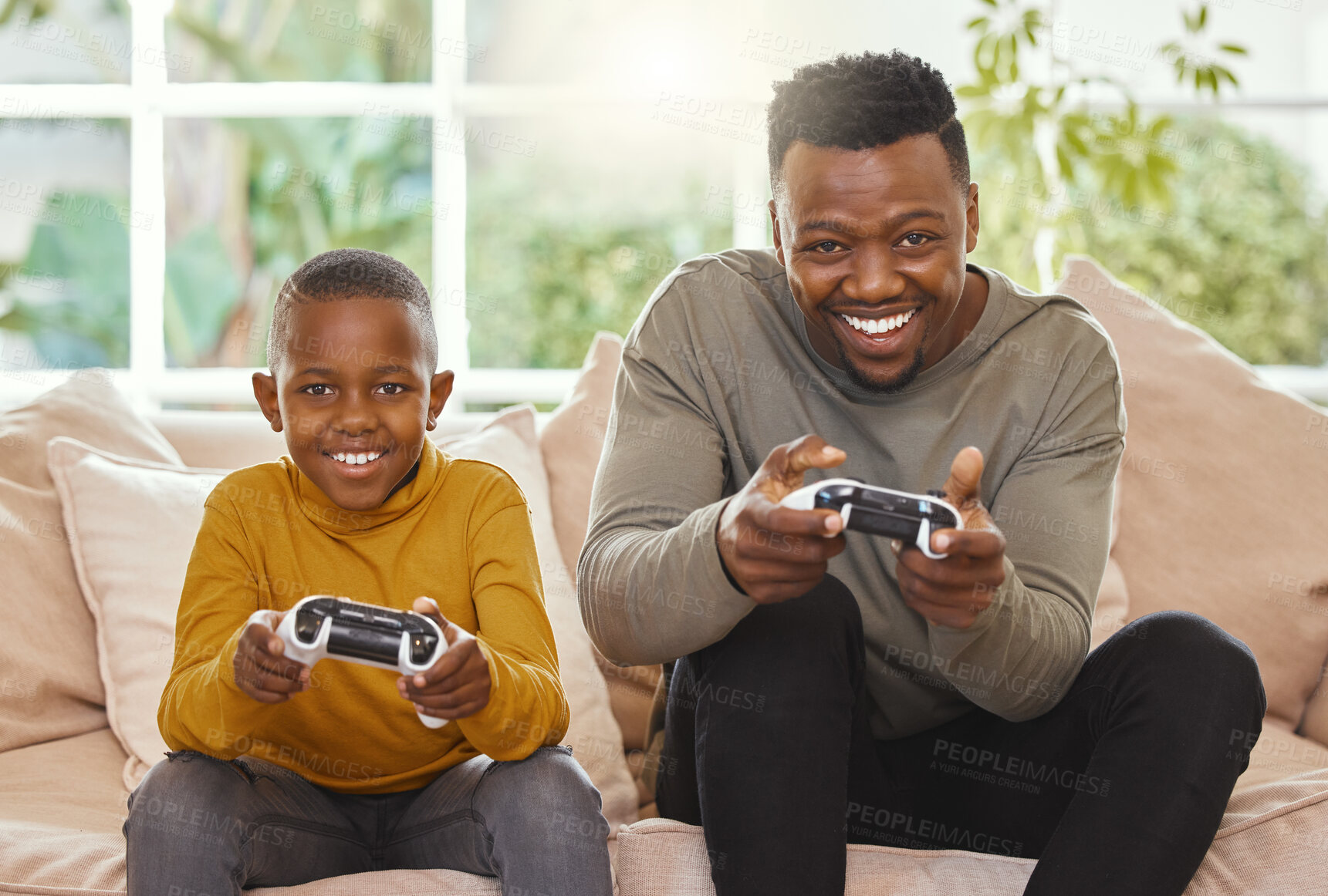 Buy stock photo Shot of a father and son gaming together