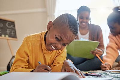 Buy stock photo Shot of a young boy completing his school work at home