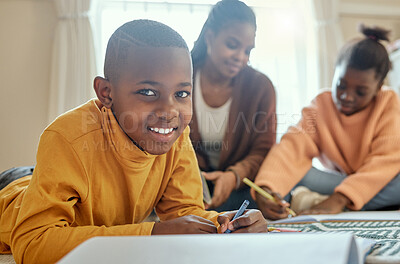 Buy stock photo Shot of a young boy completing his homework while his mom helps him and his sister