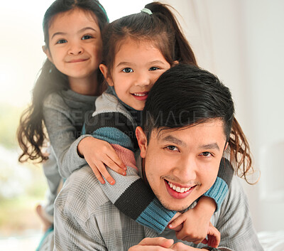 Buy stock photo Shot of a man spending time with his two daughters at home