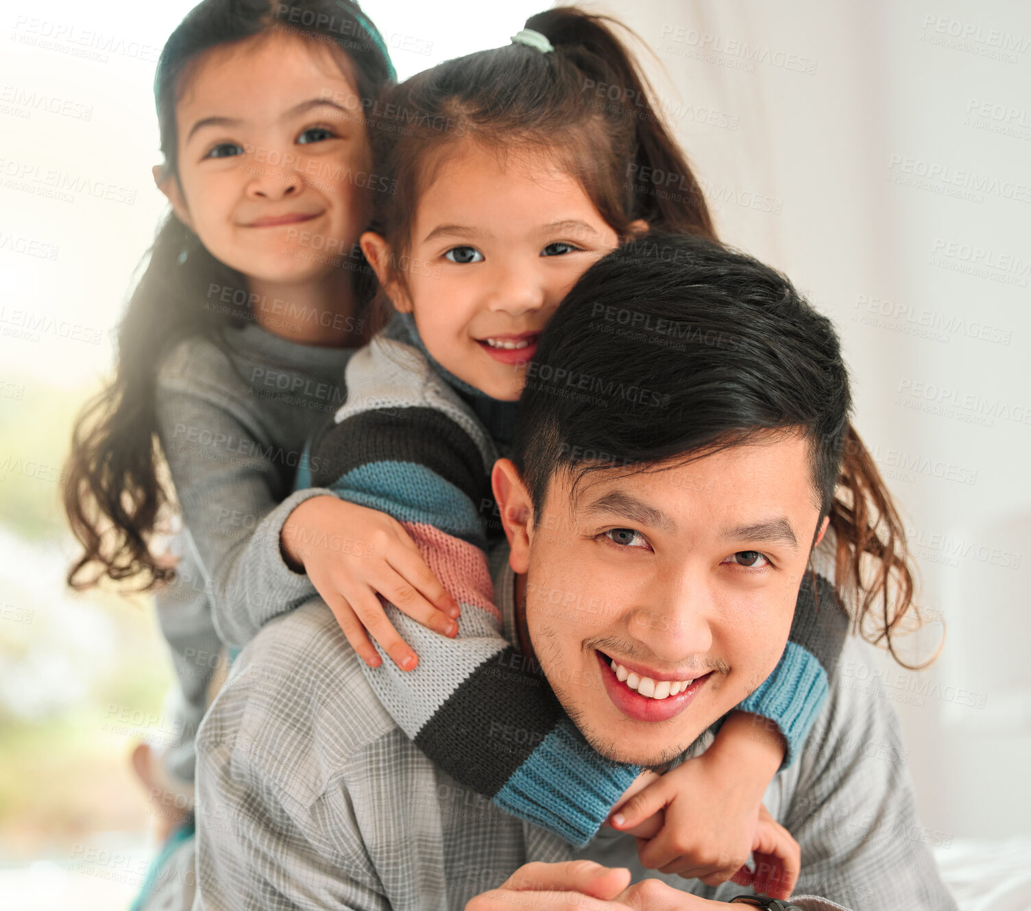 Buy stock photo Shot of a man spending time with his two daughters at home