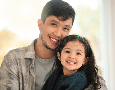 Buy stock photo Shot of a young man bonding with his daughter at home