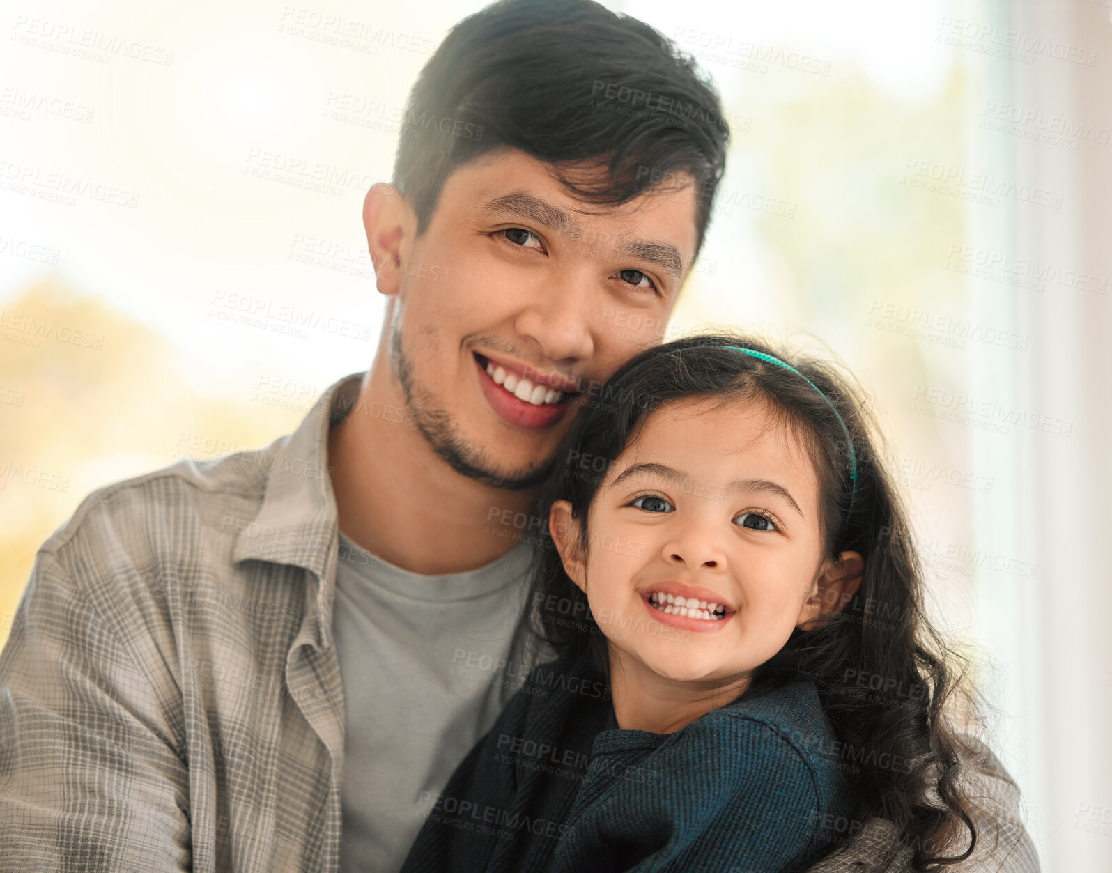 Buy stock photo Shot of a young man bonding with his daughter at home