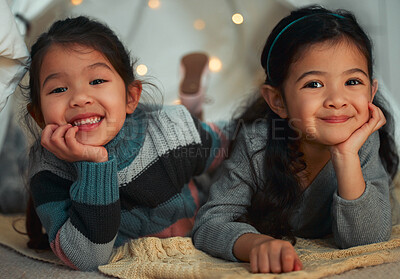 Buy stock photo Shot of two little sisters relaxing at home