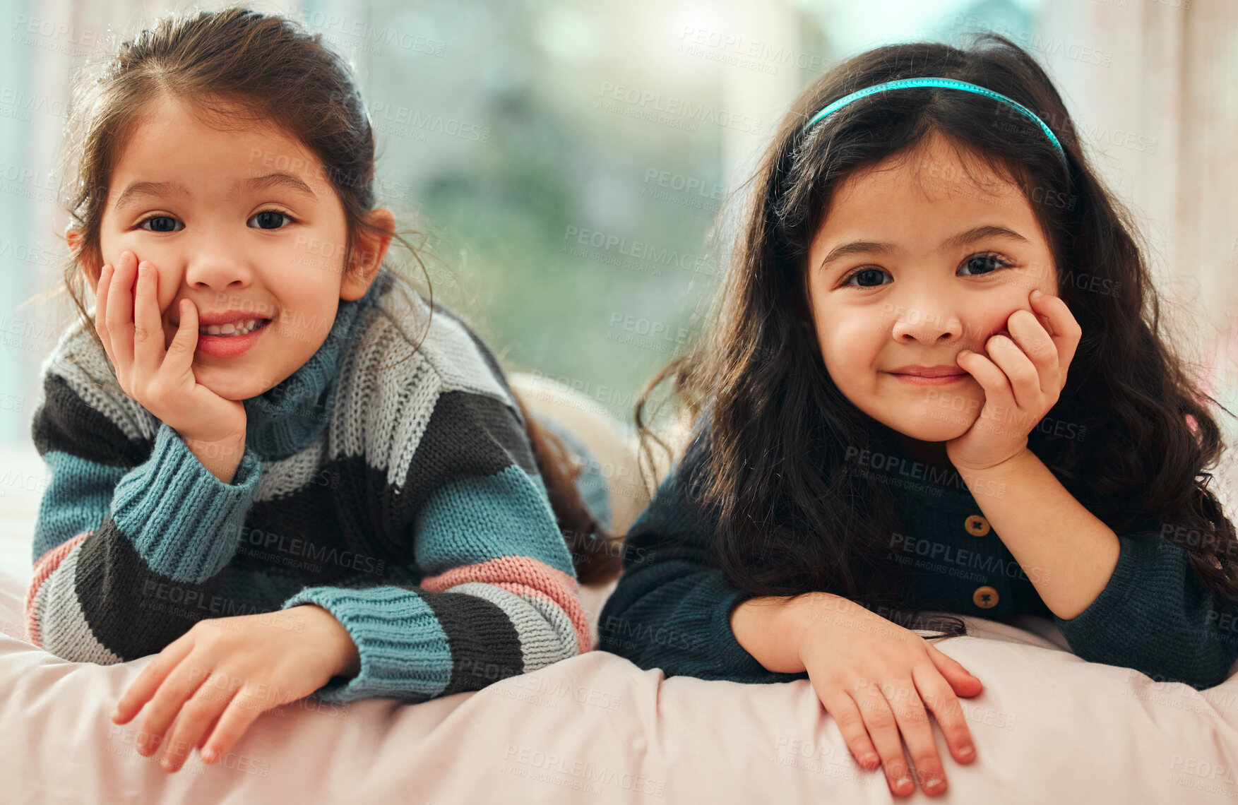 Buy stock photo Shot of two little sisters relaxing at home