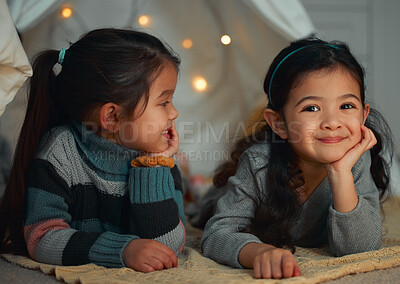 Buy stock photo Shot of two little sisters relaxing at home