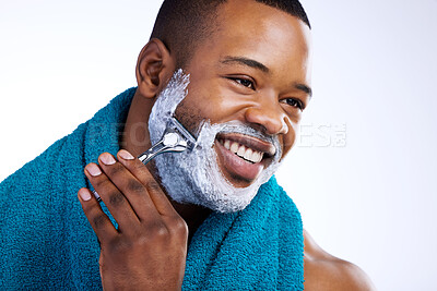 Buy stock photo Studio shot of a handsome young man shaving against a white background