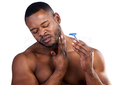 Buy stock photo Studio shot of a handsome young man wincing in pain after cutting himself while shaving against a white background