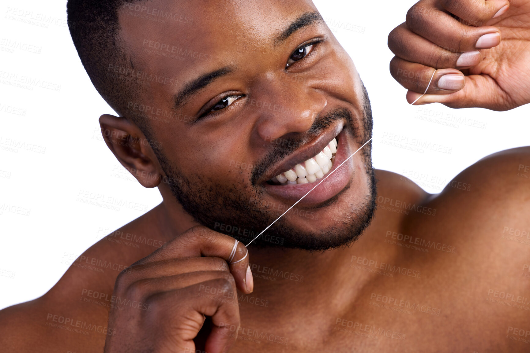 Buy stock photo Studio portrait of a handsome young man flossing against a white background
