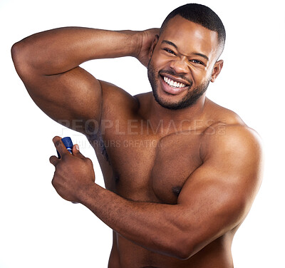 Buy stock photo Studio portrait of a handsome young man applying deodorant against a white background